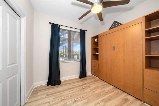 1030 Bellasol Way Unit 201, Apollo Beach, FL 33572 - unfurnished bedroom with light wood-style flooring, baseboards, and ceiling fan