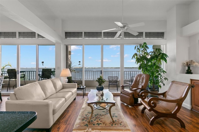 sunroom featuring a water view and ceiling fan