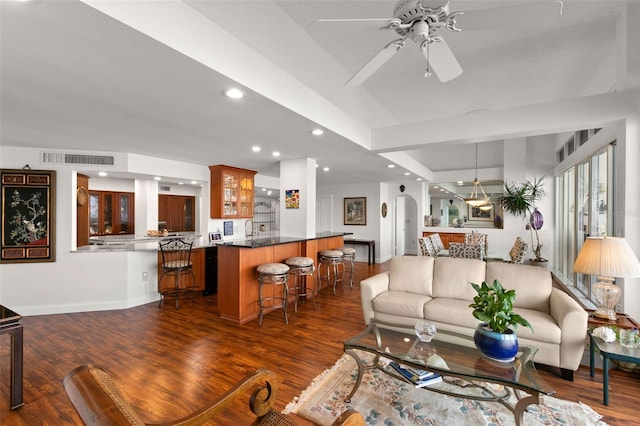 living room with ceiling fan and dark hardwood / wood-style floors