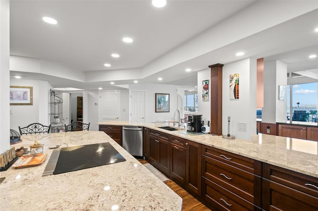 kitchen featuring black electric stovetop, dark hardwood / wood-style floors, sink, light stone countertops, and stainless steel dishwasher