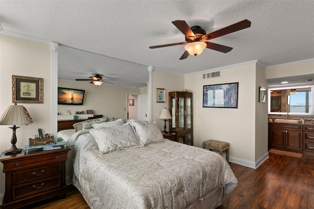 bedroom featuring ceiling fan, a textured ceiling, connected bathroom, and dark hardwood / wood-style flooring