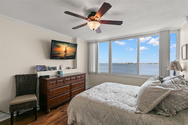 bedroom featuring a textured ceiling, crown molding, dark hardwood / wood-style floors, and ceiling fan