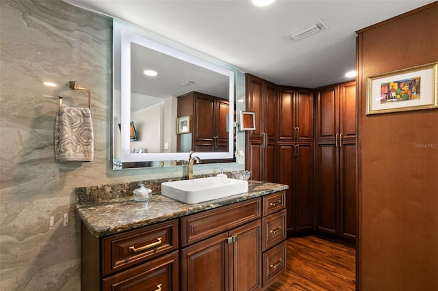 bathroom featuring vanity, tile walls, and hardwood / wood-style floors