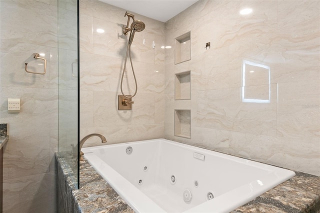 bathroom with plus walk in shower and tile walls