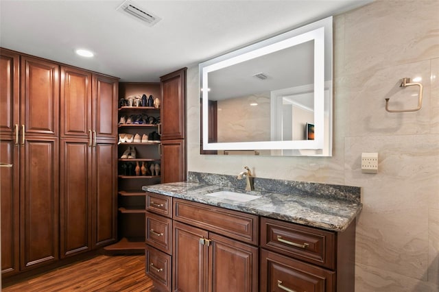 bathroom with vanity and hardwood / wood-style flooring