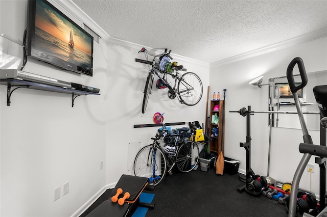 workout area featuring a textured ceiling and crown molding