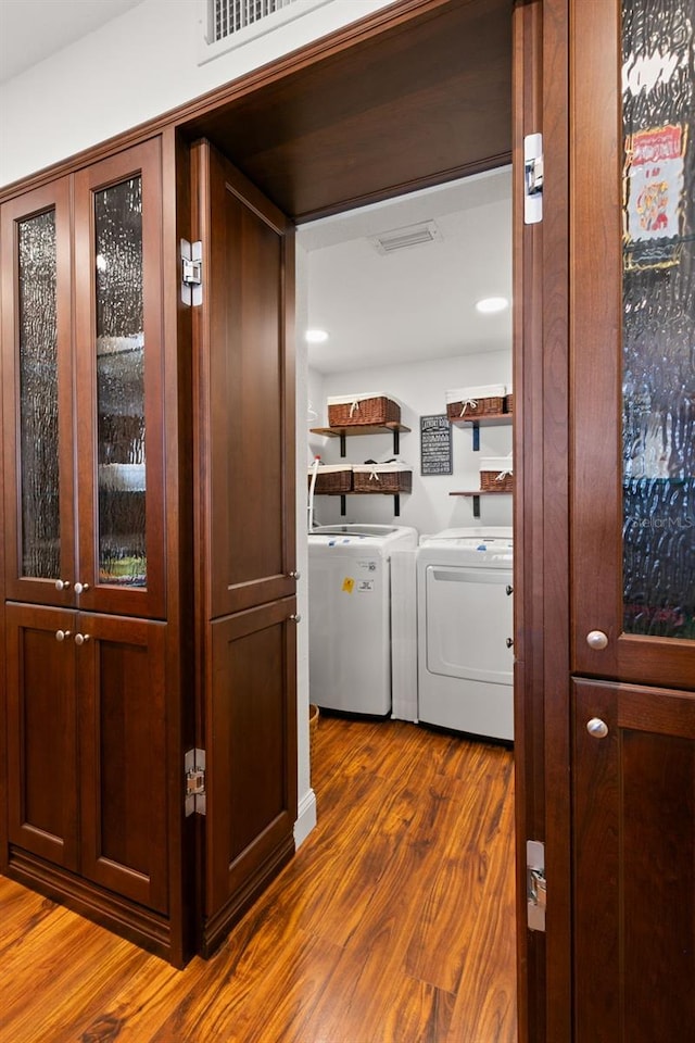 laundry area with washer and clothes dryer and dark hardwood / wood-style flooring