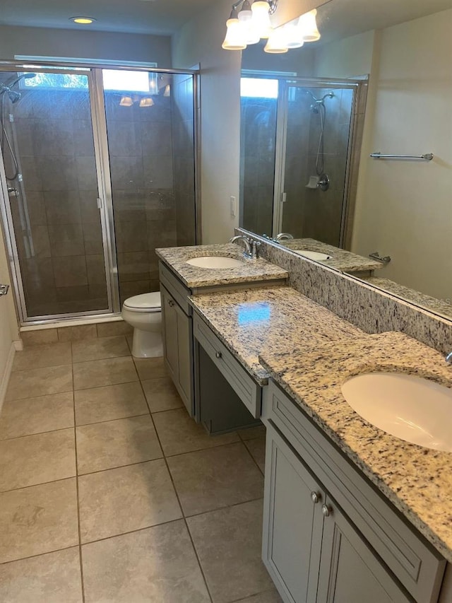 bathroom with vanity, tile patterned flooring, toilet, and an enclosed shower