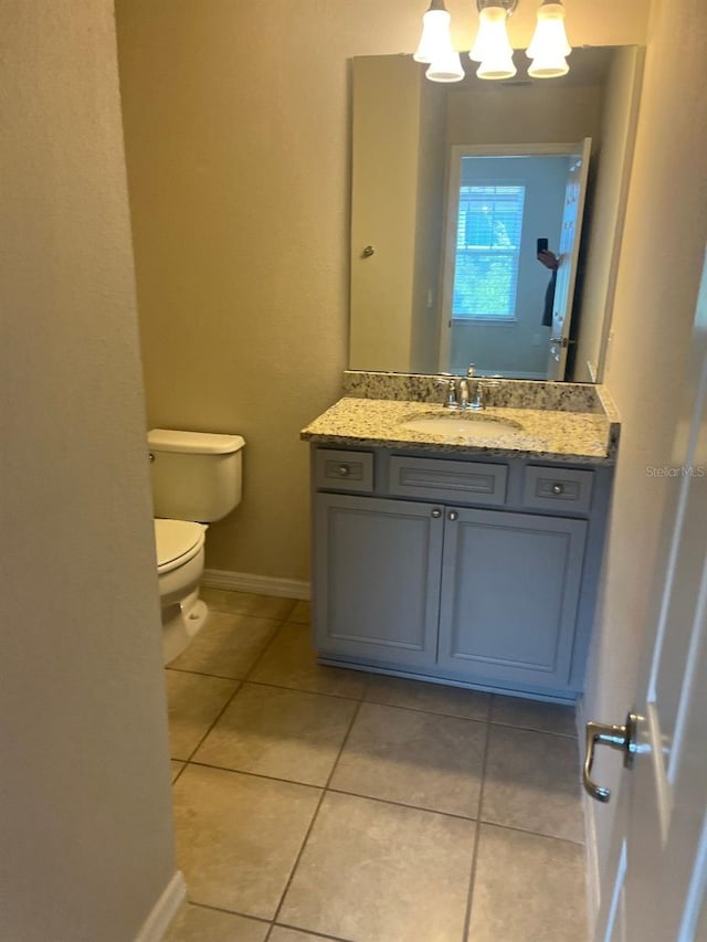 bathroom with vanity, toilet, and tile patterned floors