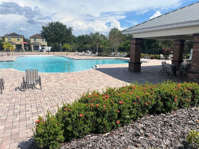 view of swimming pool with a patio