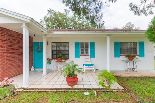 view of exterior entry with a porch