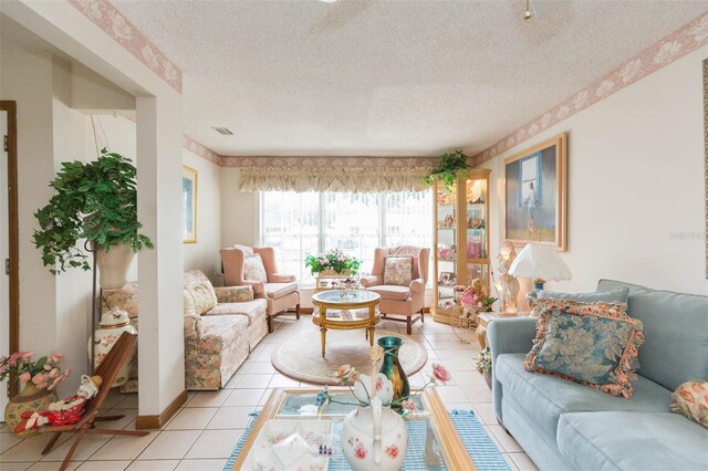 tiled living room featuring a textured ceiling