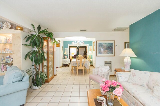 living room featuring a notable chandelier and light tile patterned floors