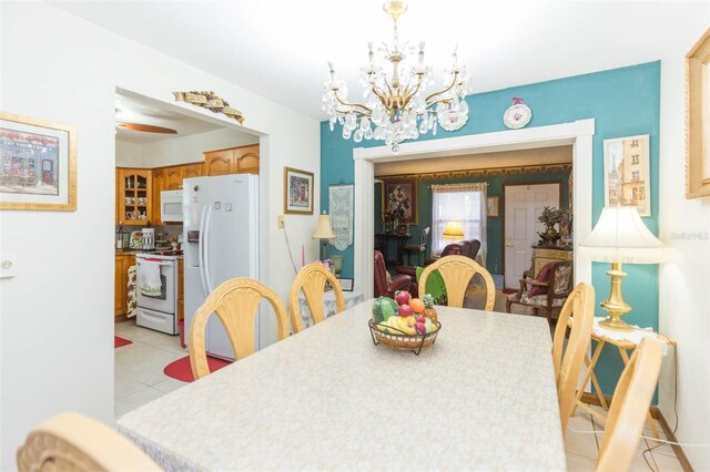 tiled dining area featuring ceiling fan