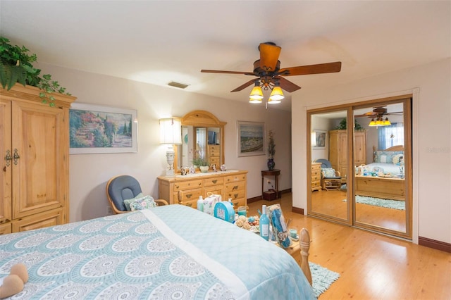 bedroom featuring light wood-type flooring, ceiling fan, and a closet