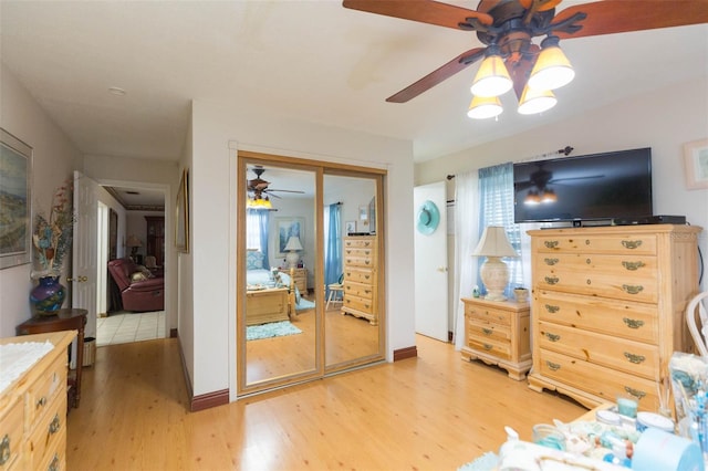 bedroom featuring hardwood / wood-style floors, ceiling fan, and a closet