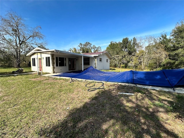 rear view of property with a lawn and a patio area