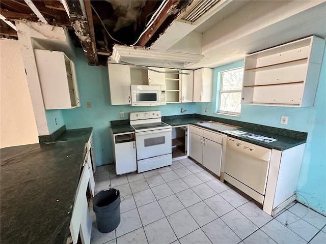17025 Dalberg Dr, Spring Hill, FL 34610 - kitchen with white appliances, dark countertops, open shelves, white cabinetry, and light tile patterned floors