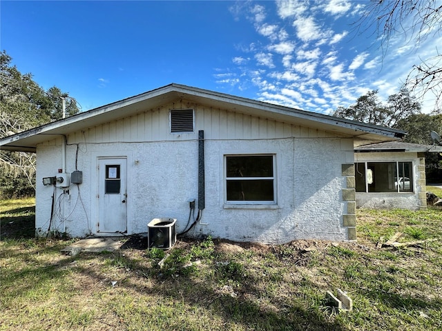 17025 Dalberg Dr, Spring Hill, FL 34610 - view of side of home with cooling unit and stucco siding