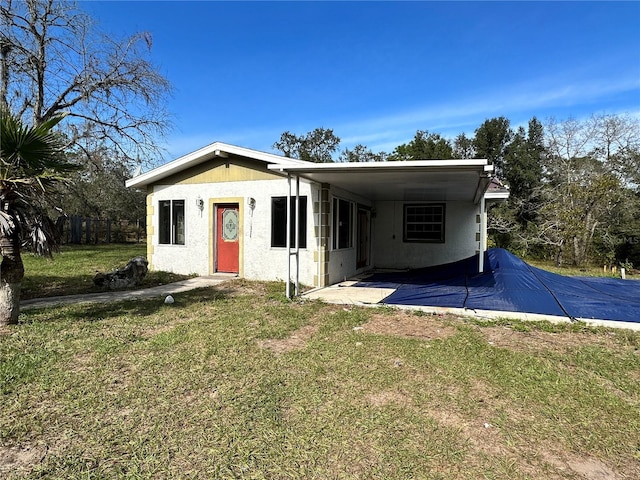 view of front of house with a carport and a front yard