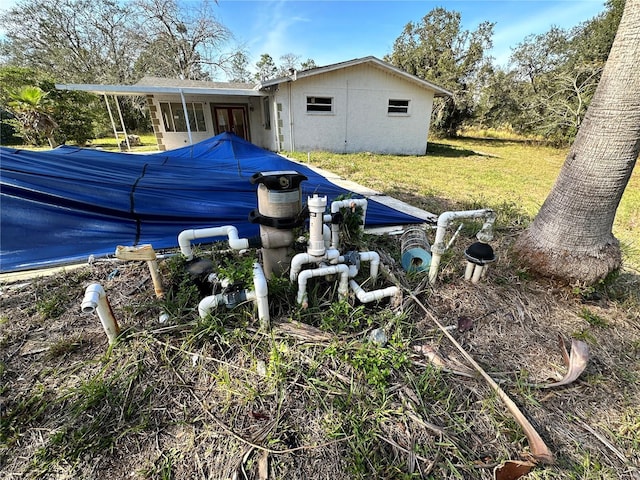 17025 Dalberg Dr, Spring Hill, FL 34610 - back of house featuring a lawn, french doors, and a pool
