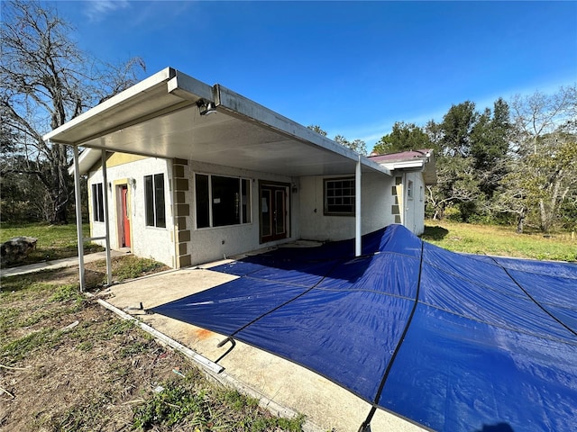 back of property with a patio