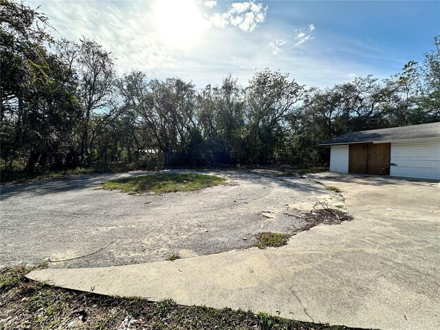 17025 Dalberg Dr, Spring Hill, FL 34610 - view of yard with a detached garage and an outdoor structure