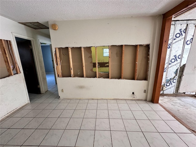 unfurnished room featuring a textured ceiling