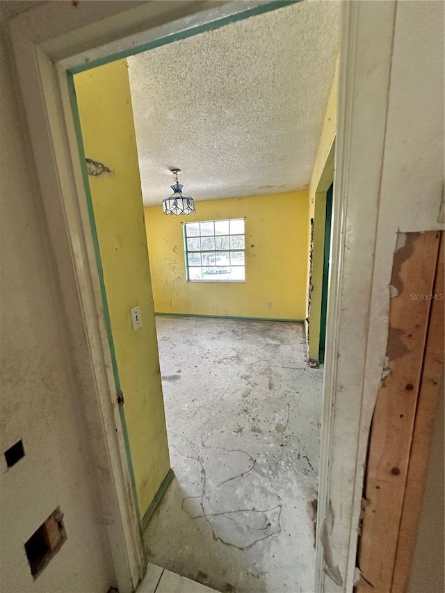 17025 Dalberg Dr, Spring Hill, FL 34610 - hallway featuring a textured ceiling