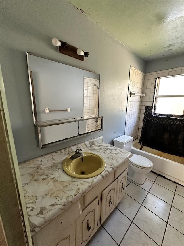 full bathroom with tile patterned flooring, vanity, toilet, and tiled shower / bath