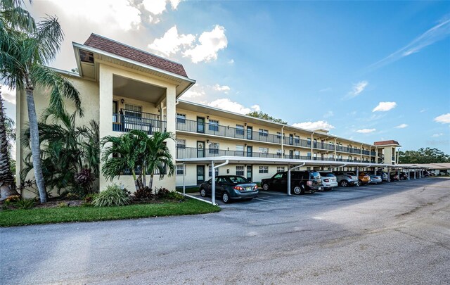 1450 Heather Ridge Blvd Unit 107, Dunedin, FL 34698 - view of building exterior featuring covered parking