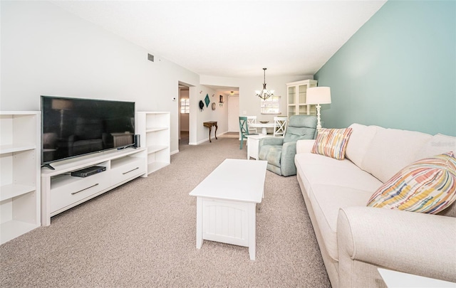 carpeted living room with a chandelier