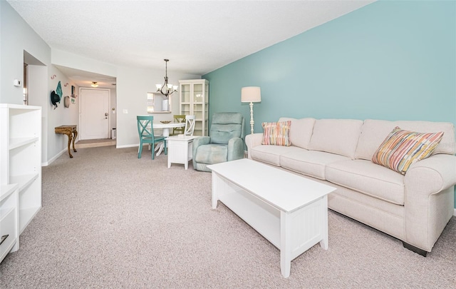 living room featuring a chandelier and light carpet