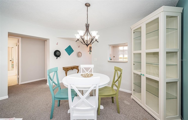 1450 Heather Ridge Blvd Unit 107, Dunedin, FL 34698 - carpeted dining space with a chandelier, baseboards, and a textured ceiling