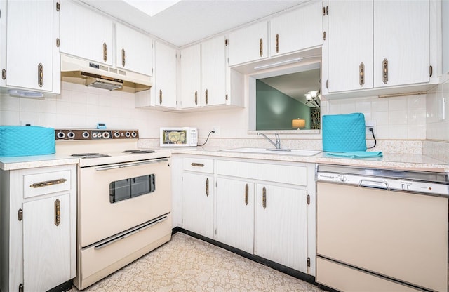 kitchen with white cabinetry, sink, backsplash, and white appliances