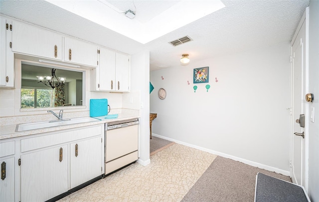 kitchen with sink, dishwasher, a textured ceiling, white cabinets, and a chandelier