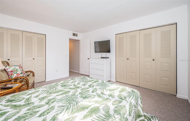 carpeted bedroom featuring a textured ceiling