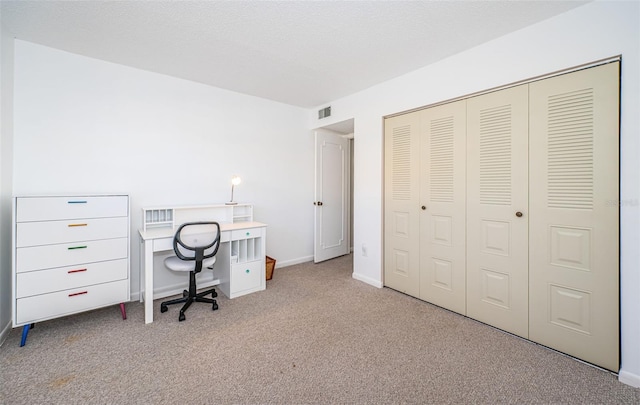 unfurnished office featuring light colored carpet