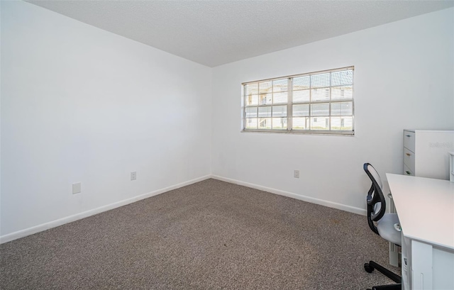 unfurnished office with carpet floors and a textured ceiling