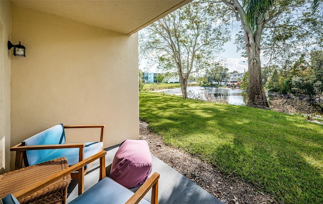1450 Heather Ridge Blvd Unit 107, Dunedin, FL 34698 - view of green lawn featuring a water view