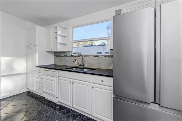 kitchen with white cabinets, sink, tasteful backsplash, stainless steel refrigerator, and dishwasher