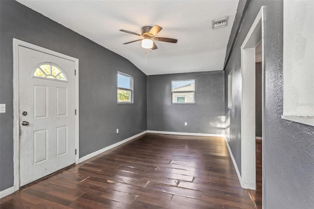 entryway featuring ceiling fan, vaulted ceiling, a textured ceiling, and dark hardwood / wood-style flooring