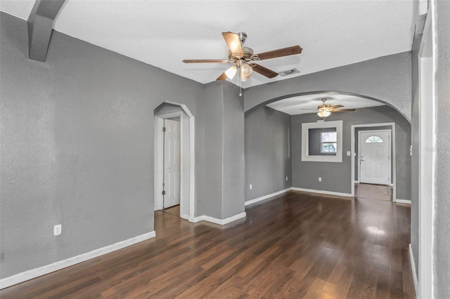 interior space with ceiling fan and dark hardwood / wood-style floors