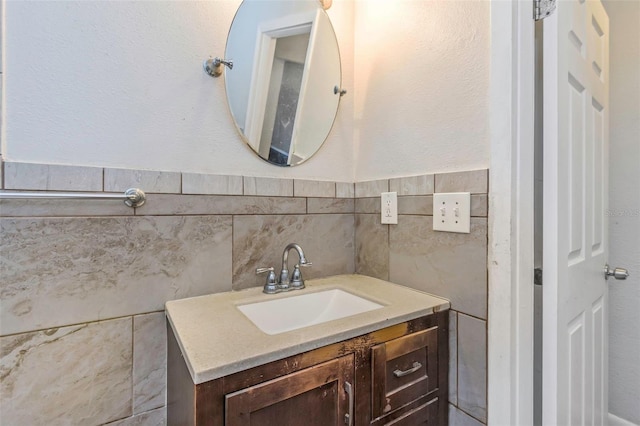 bathroom with vanity and tile walls