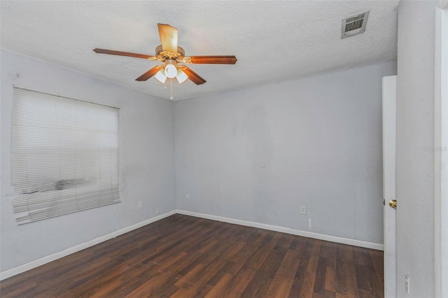 unfurnished room featuring ceiling fan, dark wood-type flooring, and a textured ceiling