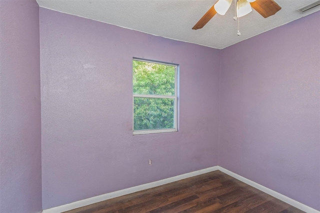 empty room featuring a textured ceiling, dark hardwood / wood-style floors, and ceiling fan