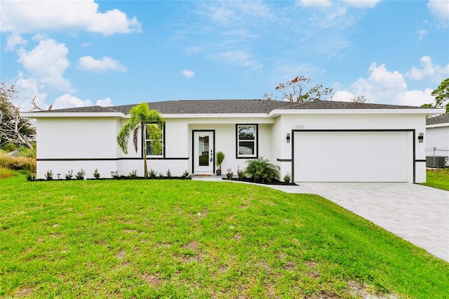 single story home with cooling unit, a front yard, and a garage