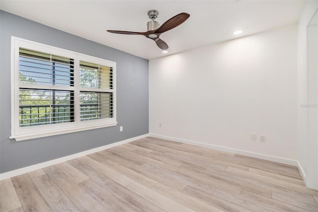 spare room with light wood-type flooring and ceiling fan