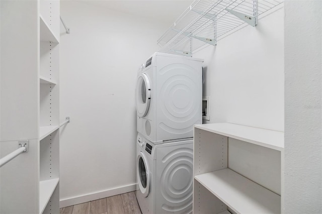 washroom featuring light wood-type flooring and stacked washer and dryer