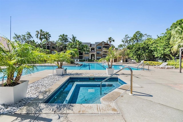 view of pool featuring a patio area and a hot tub